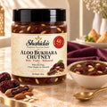 Shahida's Kitchen Aloo Bukhara Chutney 300g jar with a bowl of chutney, almonds and dried fruit